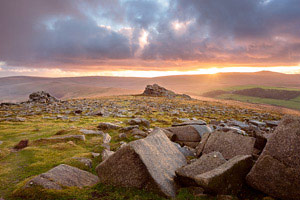 Glimpse of the sun as it sets over Higher Tor, Dartmoor